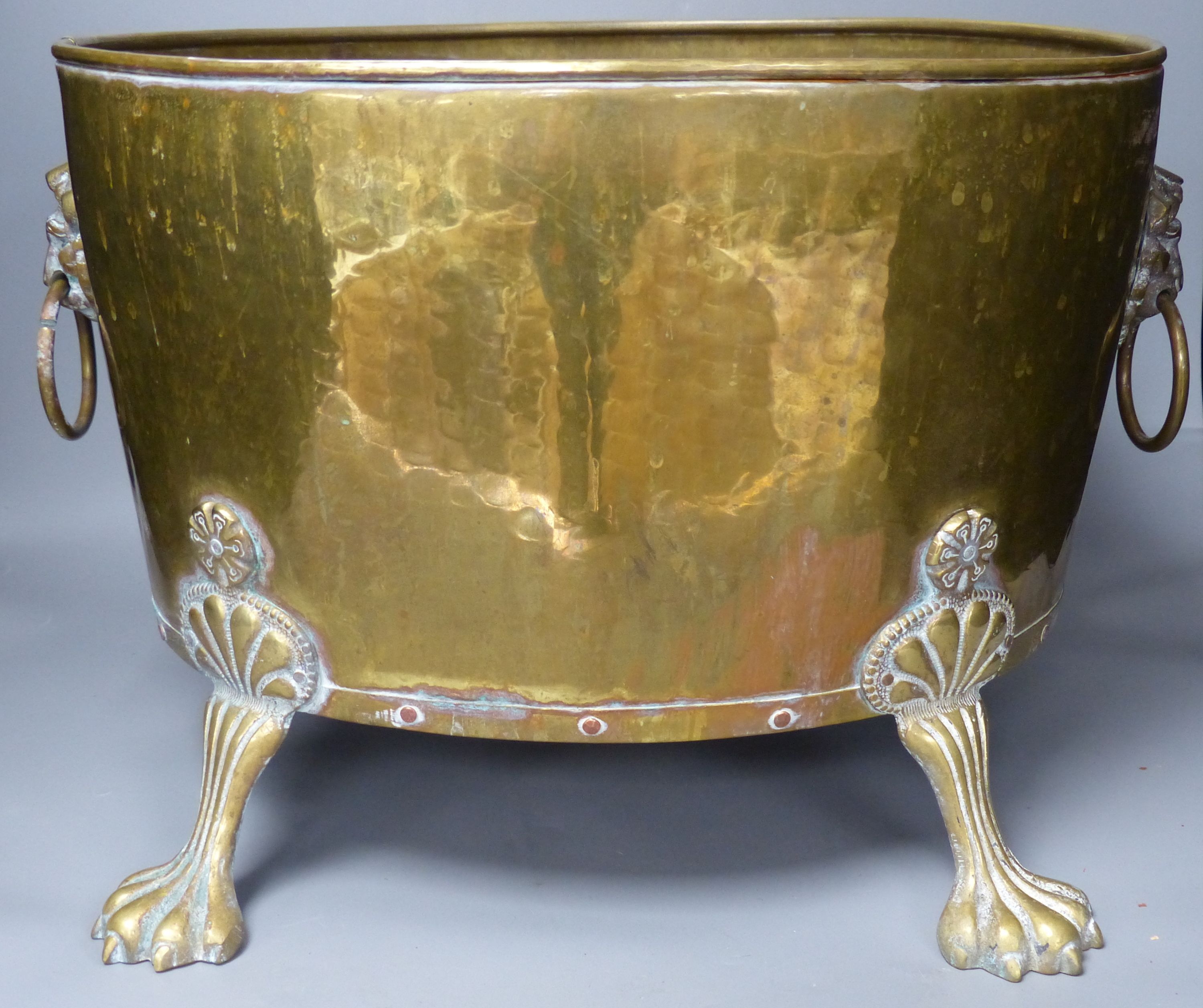 A planished brass wine cooler or jardiniere, approximate length 45cm